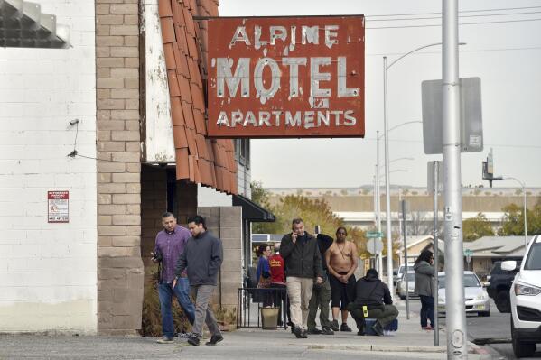 FILE - In this Dec. 21, 2019 file, photo, investigators work the scene of a fire at a three-story apartment complex in Las Vegas. Aging multi-unit and extended-stay buildings in Las Vegas that have been converted from motels or hotels to apartments will be regularly inspected as a legacy of the deadliest residential fire in the city's history in December 2019, city officials decided.   (AP Photo/David Becker, File)