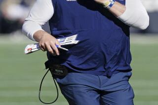 Georgia Tech head coach Geoff Collins speaks to an official in the first half of an NCAA college football game against Georgia, Saturday, Nov. 27, 2021, in Atlanta. (AP Photo/John Bazemore)