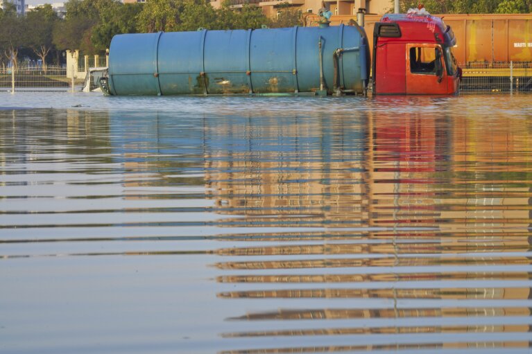 A tanker truck sits abandoned in floodwater in Dubai, United Arab Emirates, Thursday, April 18, 2024. The United Arab Emirates attempted to dry out Thursday from the heaviest rain the desert nation has ever recorded, a deluge that flooded out Dubai International Airport and disrupted flights through the world's busiest airfield for international travel. (AP Photo/Jon Gambrell)