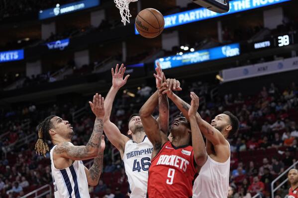 Memphis Grizzlies' John Konchar (46), Brandon Clarke, left, and Kyle Anderson, right, reach for a rebound along with Houston Rockets' Josh Christopher (9) during the first half of an NBA basketball game Sunday, March 6, 2022, in Houston. (AP Photo/David J. Phillip)