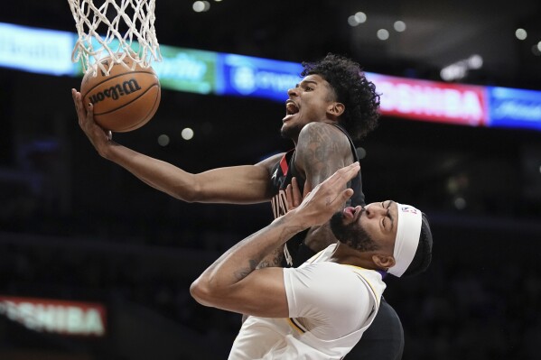 Houston Rockets guard Jalen Green, top, shoots as Los Angeles Lakers forward Anthony Davis defends during the first half of an NBA basketball game Saturday, Dec. 2, 2023, in Los Angeles. (AP Photo/Mark J. Terrill)