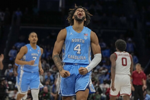 North Carolina guard RJ Davis celebrates after scoring against Oklahoma during the first half of an NCAA college basketball game Wednesday, Dec. 20, 2023, in Charlotte, N.C. (AP Photo/Chris Carlson)