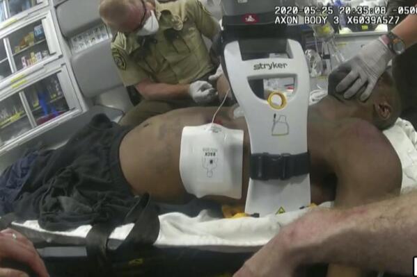 FILE - This image from police body camera video shows emergency personal tending to George Floyd after he had been loaded into an ambulance on May 25, 2020, in Minneapolis. A paramedic who treated Floyd on the day he was killed testified Wednesday, Jan. 26, 2022 at the federal civil rights trial of three former Minneapolis police officers that he wasn't told Floyd wasn't breathing and had no pulse when officers upgraded the urgency of an ambulance call. (Minneapolis Police Department via AP, File)