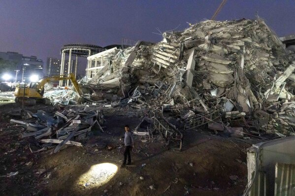 Rescuers search for victims at the site of a high-rise building under construction that collapsed after a strong earthquake in Bangkok, Thailand, early Saturday, March 29, 2025. (AP Photo/Wason Wanichakorn)