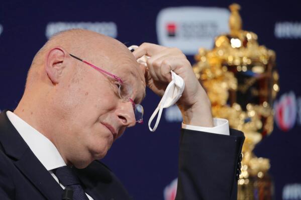 FILE - Bernard Laporte, head of the French Rugby Federation, gestures, during a press conference after the draw for the Rugby World Cup 2023, Monday, Dec. 14, 2020 in Paris. French rugby federation president Bernard Laporte has been handed a two-year suspended sentence in a corruption case. Laporte, who is also World Rugby's vice-chairman, was found guilty of passive corruption, influence peddling, illegal interest taking and misuse of corporate assets by a court in Paris.(AP Photo/Christophe Ena, File)
