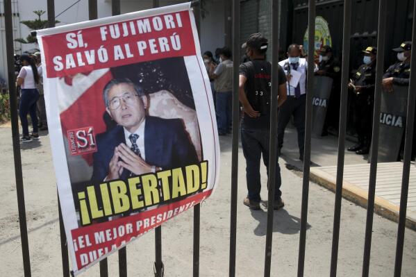 A picture of former Peruvian President Alberto Fujimori reads in Spanish "Freedom" hangs outside the jail where Fujimori is held in Lima, Peru, Tuesday, March 29, 2022. Earlier in the month, Peru's Constitutional Court approved Fujimori's release from prison where he is serving a 25-year sentence for murder and corruption charges, restoring a humanitarian pardon granted to Fujimori on Christmas Eve in 2017. (AP Photo/Guadalupe Pardo)