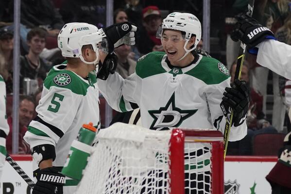 Dallas Stars' Andrej Sekera (5) celebrates with Jason Robertson (21) after Robertson's goal against the Arizona Coyotes during the second period of an NHL hockey game Saturday, Nov. 27, 2021, in Glendale, Ariz. (AP Photo/Darryl Webb)