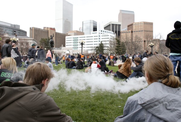 FILE - People smoke marijuana during the annual 4/20 marijuana gathering at Civic Center Park in downtown Denver, Wednesday, April 20, 2016. (AP Photo/Brennan Linsley, File)