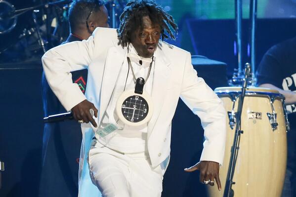 FILE - Flavor Flav of Public Enemy performs during the band's induction at the Rock and Roll Hall of Fame Induction Ceremony at the Nokia Theatre in Los Angeles on April 18, 2013. Attorneys for entertainer Flavor Flav said Wednesday, Dec. 8, 2021, he's working to stay sober following the dismissal of a misdemeanor domestic violence charge stemming from a scuffle with his girlfriend at home in suburban Las Vegas. (Photo by Danny Moloshok/Invision/AP, File)