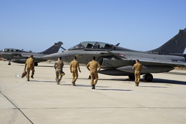Image provided from Ministry of Defence of the Republic of Cyprus, French pilots walk towards to the Rafael aircrafts during a military exercise between Cyprus, France, Italy and Greece, in Paphos air base in southwest of the eastern Mediterranean island of Cyprus, on Thursday, Sept. 14, 2023. The president of Cyprus Nikos Christodoulides says joint military maneuvers between Cyprus, France, Italy and Greece demonstrates the readiness of the four European Union members to ensure conditions of security and stability in the eastern Mediterranean. (Ministry of Defence of the Republic of Cyprus via AP)