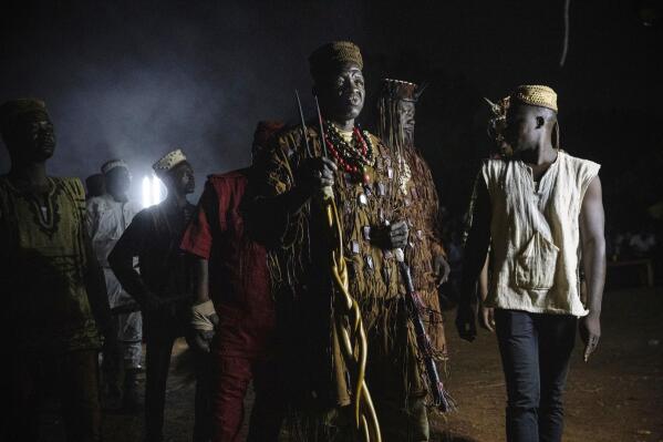 Dozos, ancient hunters who have been drawn into the Islamic extremist fight, participate in a celebration of their culture in Bobo-Dioulasso, Burkina Faso, 360 kilometers (220 miles) west of the capital, Ouagadougou, on Sunday, March 28, 2021. Fighters are putting their faith in traditional spiritual practices to protect them as attacks linked to al-Qaida and the Islamic State ravage the West African nation, killing thousands and displacing more than 1 million people. (AP Photo/Sophie Garcia)