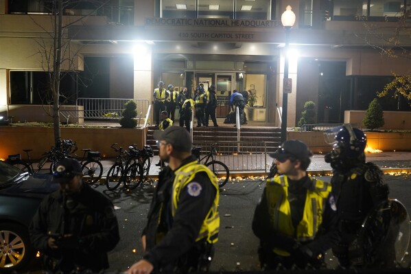 U.S. Capitol Police stand outside the headquarters of the Democratic National Committee Wednesday, Nov. 15, 2023, in Washington. (AP Photo/Nathan Howard)