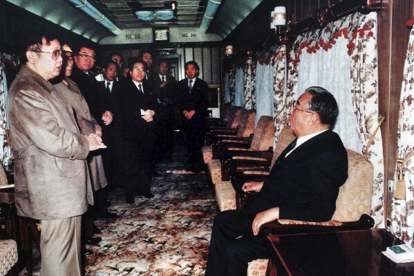 FILE - In this photo from North Korea's official Korean Central News Agency, distributed by Korea News Service, leader Kim Il Sung, right, and Kim Jong Il have a conversation in a special train before an unofficial visit to China, in November 1989. North Korea’s Kim Jong Un's train journey to Russia has a storified history. The tradition of train travel extends across the generations. That’s in evidence at the massive Kumsusan Palace of the Sun, where reconstructions of Kim Jong Un’s father’s and grandfather’s train cars, and the leaders’ preserved and displayed remains, are enshrined. (Korean Central News Agency/Korea News Service via AP Images, File)