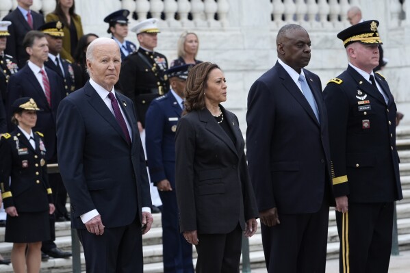 President Joe Biden, left, joined by, from left, Vice President Kamala Harris, Defense Secretary Lloyd Austin and Army Major Gen. Trevor Bradenkamp, pause during an Armed Forces Full Honors Wreath Ceremony at the Tomb of the Unknown Soldier at Arlington National Cemetery in Arlington, Va., on Memorial Day, Monday, May 27, 2024. (AP Photo/Susan Walsh)