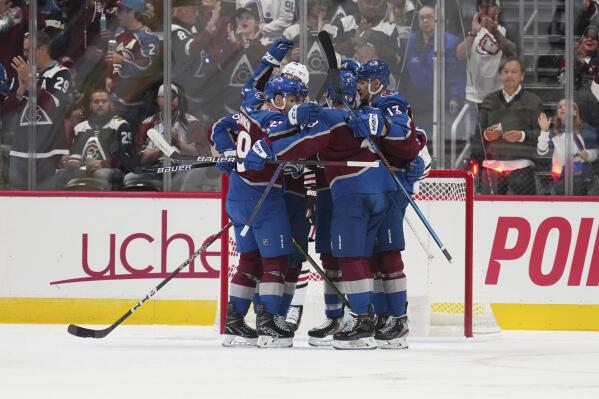 Colorado Avalanche left wing Artturi Lehkonen (62) is congratulated by teammates after scoring a goal against the Chicago Blackhawks during the second period of an NHL hockey game Wednesday, Oct. 12, 2022, in Denver. (AP Photo/Jack Dempsey)