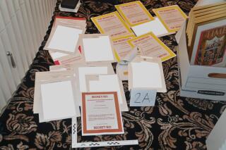 FILE - This image contained in a court filing by the Department of Justice on Aug. 30, 2022, and partially redacted by the source, shows a photo of documents seized during the Aug. 8 FBI search of former President Donald Trump's Mar-a-Lago estate. Lawyers for fTrump have in recent months turned over to federal investigators additional documents with classified markings as well as a laptop belonging to a Trump aide.(Department of Justice via AP, File)