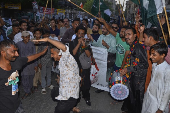 People dance on traditional drum beat as they celebrate following India and Pakistan reaching a ceasefire deal, during a demonstration, in Hyderabad, Pakistan, Saturday, May 10, 2025. (AP Photo/Pervez Masih)