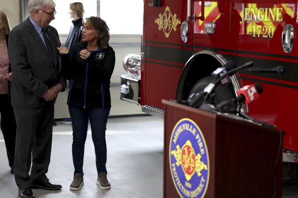 Missouri Rep. Jim Murphy, left, speaks with Monica Kelsey, founder of the Safe Haven Baby Box, right, before a news conference on Monday, Feb. 12, 2024, at the Mehlville Fire District Station 2 in south St. Louis County, Mo. A newborn baby is healthy and in state custody after being left in the station's box on Thursday, Feb. 8. (Christine Tannous/St. Louis Post-Dispatch via AP)