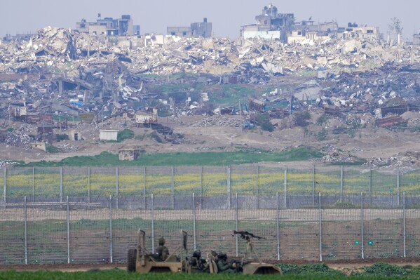 Israeli soldiers drive near the border with the Gaza Strip, as seen in southern Israel, Tuesday, Feb. 6, 2024. (AP Photo/Tsafrir Abayov)