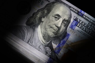 File - The likeness of Benjamin Franklin is seen on U.S. $100 bills, Thursday, July 14, 2022, in Marple Township, Pa. With the help of technology, scammers are tricking Americans out of more money than ever before. But there are steps you can take to keep your money and information safe. (AP Photo/Matt Slocum, File)