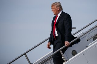 
              President Donald Trump walks off Air Force One after arriving at Evansville Regional Airport, Thursday, Aug. 30, 2018, in Evansville, Ind. (AP Photo/Evan Vucci)
            