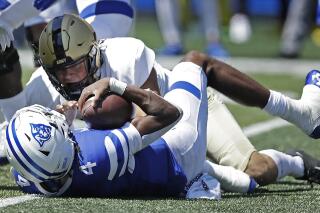 FILE - Georgia State quarterback Cornelious Brown IV (4) is tackled by Army linebacker Andre Carter II during the first quarter of an NCAA football game Saturday, Sept. 4, 2021, in Atlanta. Army plays Missouri in the Armed Forces Bowl on Wednesday, Dec. 22. (AP Photo/Ben Margot, File)