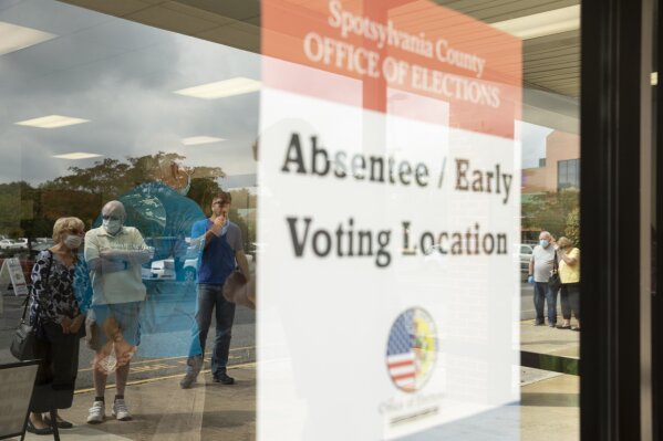 Voters wait in line to cast ballots in the general election, Friday, Sept. 18, 2020, at the Office of Elections satellite location in Spotsylvania, Va., on the first day of the state's 45-day early voting period. (Mike Morones/The Free Lance-Star via AP)