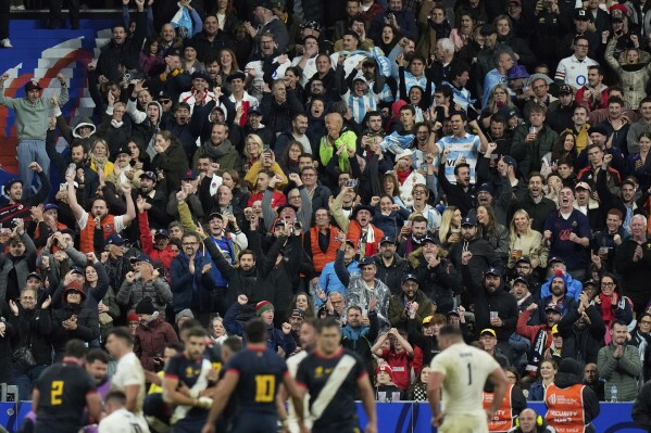 Supporters of Argentina react after Argentina's Tomas Cubelli scored a try during the Rugby World Cup third place match between England and Argentina at the Stade de France in Saint-Denis, outside Paris, Friday, Oct. 27, 2023. (AP Photo/Pavel Golovkin)