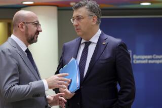 European Council President Charles Michel, left, speaks with Croatia's Prime Minister Andrej Plenkovic during a round table meeting at an EU summit in Brussels, Friday, June 24, 2022. EU leaders were set to discuss economic topics at their summit in Brussels Friday amid inflation, high energy prices and a cost of living crisis. (AP Photo/Olivier Matthys)