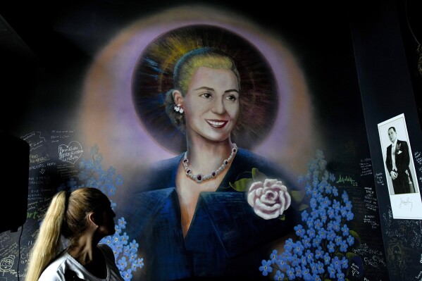 A mural of Argentine former first lady María Eva Duarte de Perón, better known as Eva Perón, or Evita, depicting her with a saint's halo, adorns a wall inside the Peron Peron restaurant in the San Telmo neighborhood of Buenos Aires, Argentina, Friday, Feb. 9, 2024. (AP Photo/Natacha Pisarenko)