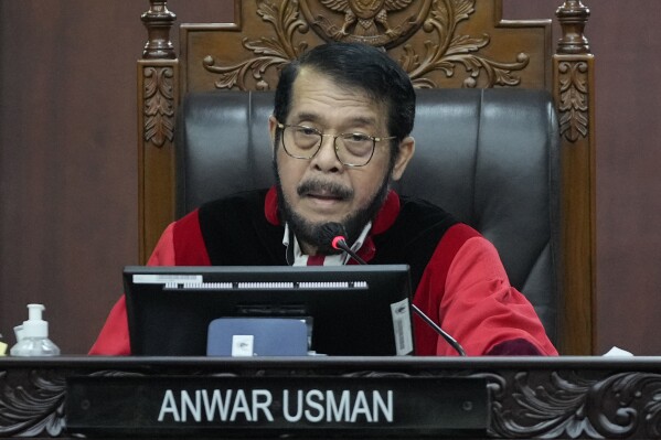 FILE - Chief Justice of the Constitutional Court Anwar Usman presides over the hearing on a petition seeking to lower the minimum age of presidential and vice presidential candidates at the Constitutional Court in Jakarta, Indonesia, Monday, Oct. 16, 2023. Ethics council chief Jimly Asshiddiqie said in a verdict that the Constitutional Court’s Chief Justice Anwar Usman found guilty of making last-minute changes to election candidacy requirements that cleared way for ongoing President Joko Widodo’s eldest son, Gibran Rakabuming Raka, 36, to run for vice president in the election next year. (AP Photo/Achmad Ibrahim, File)