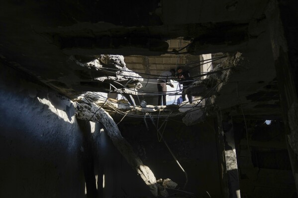 Palestinians inspect the site where the Israeli military struck what it said was a hideout for militants, in the Balata refugee camp in the occupied West Bank, Nov. 18, 2023. The Palestinian Red Crescent ambulance service said five Palestinians were killed in the strike.(AP Photo/Majdi Mohammed)