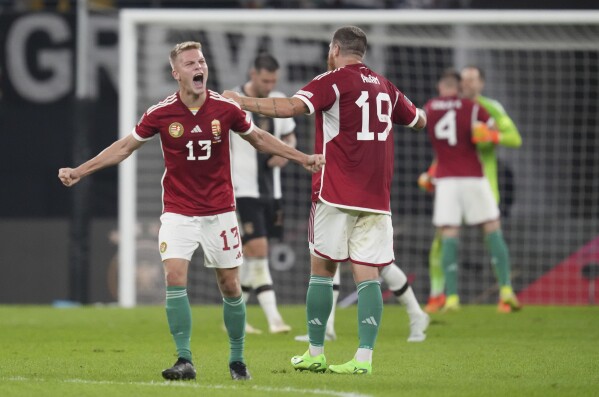FILE - Hungary's Andras Schafer, left, and Hungary's Martin Adam celebrate their victory in the UEFA Nations League soccer match between Germany and Hungary at the Red Bull Arena in Leipzig, Germany, Friday, Sept. 23, 2022. Host nation Germany may be the heavyweight in its European Championship group, but any of Scotland, Hungary or Switzerland is capable of causing an upset in Group A. (AP Photo/Michael Sohn, File)