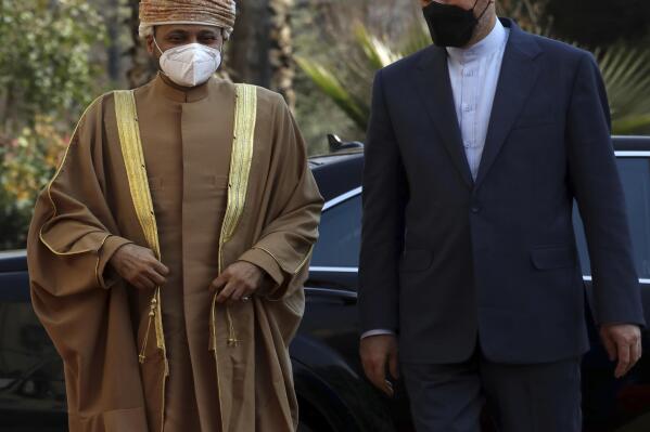 Iranian Foreign Minister Hossein Amirabdollahian, right, welcomes Omani Foreign Minister Sayyid Badr Albusaidi, in Tehran, Iran, Wednesday, Feb. 23, 2022. Oman has often acted as a go-between to help facilitate back-door diplomacy between the U.S. and Iran, and the visit raised speculation that Oman may get involved as an intermediary in the ongoing nuclear talks, or deliver a U.S. message to Iran. (AP Photo/Vahid Salemi)