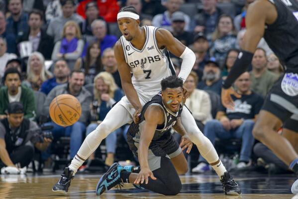 San Antonio Spurs guard Josh Richardson (7) and Sacramento Kings guard Malik Monk (0) chase the ball during the first quarter of an NBA basketball game in Sacramento, Calif., Thursday, Nov. 17, 2022. (AP Photo/Randall Benton)