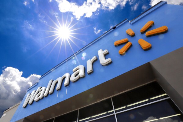 FILE - A Walmart sign is displayed over the entrance to a store on June 25, 2019 in Pittsburgh. Walmart is raising the starting base pay for store managers, while redesigning its bonus plan that will put more of an emphasis on profits for these leaders. The moves, announced Thursday, Jan. 18, 2024, will be effective Feb. 1. (AP Photo/Gene J. Puskar, File)