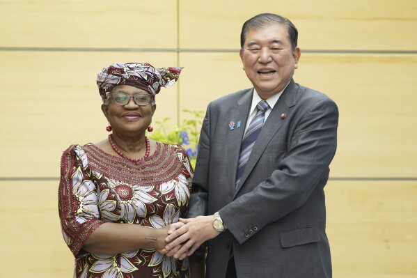 World Trade Organization (WTO) Director-General Ngozi Okonjo-Iweala, left, shakes hands with Japan's Prime Minister Shigeru Ishiba at the latter's office in Tokyo Tuesday, May 13, 2025. (Kazuhiro Nogi/Pool Photo via AP)