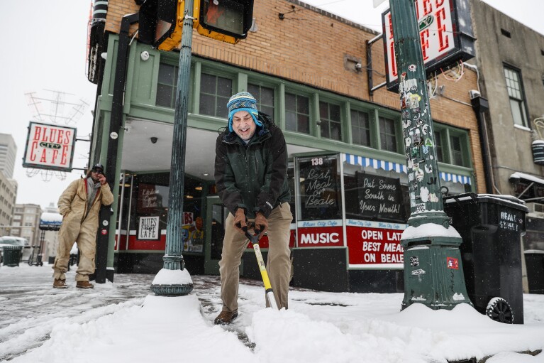 Ken Whitehead clears the sidewalk out of doorways Blues City Cafe as snow falls on Monday, Jan. 15, 2024 in Memphis, Tenn. (Mark Weber/Day to day Memphian by the expend of AP)