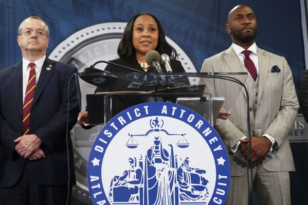 FILE - Fulton County District Attorney Fani Willis, center, speaks along side special prosecutor Nathan Wade, right, during a news conference at the Fulton County Government Center, Monday, Aug. 14, 2023, in Atlanta. Willis acknowledged in a court filing on Friday, Feb. 2, 2024, having a “personal relationship” with Wade, a special prosecutor she hired for the Georgia election interference case against former President Donald Trump, but argued there are no grounds to dismiss the case or to remove her from the prosecution. (AP Photo/John Bazemore, File)