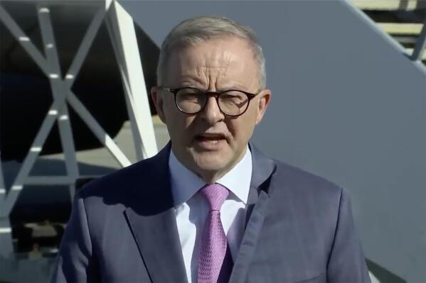 In this image from a video, Australian Prime Minister Anthony Albanese speaks to reporters ahead of his departure in Perth, Australia Wednesday, March 8, 2023. Albanese said Wednesday he plans to meet with President Joe Biden in the United States following a trip to India this week, amid speculation the leaders will make an announcement about Australia's plans to build nuclear submarines. (Australia Pool via AP)