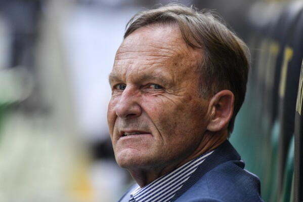 FILE - Borussia Dortmund CEO Hans Joachim Watzke sits on the bench prior the German Bundesliga soccer match between Borussia Moenchengladbach and Borussia Dortmund in Moenchengladbach, Germany, Saturday, May 18, 2019. Borussia Dortmund chief executive Hans-Joachim 