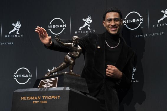 Alabama quarterback Bryce Young poses for a photograph after winning the Heisman Trophy, Saturday, Dec. 11, 2021, in New York. (AP Photo/John Minchillo)