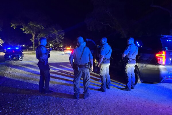 In this photo provided by the Horry County Police Department, police officers respond to the scene of a shooting on Sunday, May 25, 2025, in Little River, S.C. (Horry County Police Department via AP)