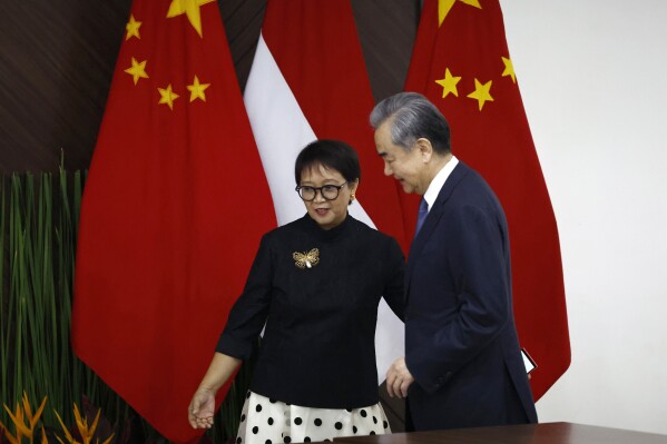 Chinese Foreign Minister Wang Yi, right, walks with Indonesian Foreign Minister Retno Marsudi during their bilateral meeting in Jakarta, Indonesia, Thursday, April 18, 2024. (Willy Kurniawan/Pool Photo via AP)