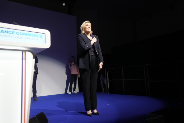 French far right leader Marine Le Pen gestures after delivering her speech after the release of projections based on the actual vote count in select constituencies in Henin-Beaumont, northern France, Sunday, June 30, 2024. (AP Photo/Thibault Camus)