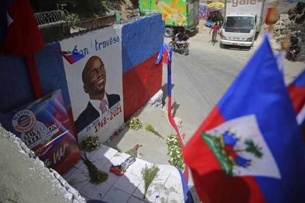 FILE - In this July 21, 2021 file photo, a mural depicting the late President Jovenel Moise adorns a wall in the Kenscoff neighborhood of Port-au-Prince, Haiti. A police superintendent in Jamaica told The Associated Press on Thursday, Oct. 21, 2021, that authorities have arrested a Colombian man they believe is a suspect in the July 7 assassination of Moise. (AP Photo/Joseph Odelyn)