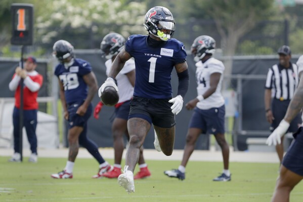 Houston Texans wide receiver Stefon Diggs (1) runs a play during practice at the NFL football team's minicamp, Tuesday, June 4, 2024, in Houston. (AP Photo/Michael Wyke)