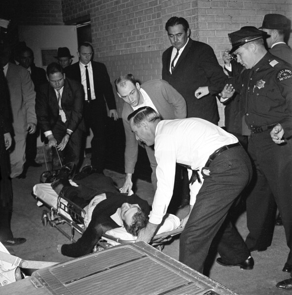 Lee Harvey Oswald, accussed assassin of President John F. Kennedy, is placed on a stretcher after being shot in the stomach in Dallas, Texas, Sunday, Nov. 24, 1963.  Nightclub owner Jack Ruby shot and killed Oswald as the prisoner was being transferred through the underground garage of Dallas police headquarters.  (AP Photo/David F. Smith)