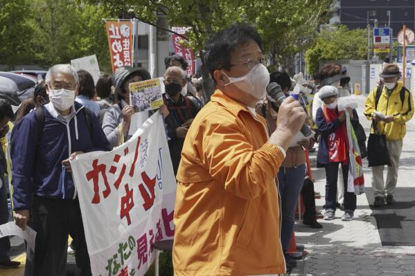 Protesters gather in front of Osaka prefectural head office in Osaka, western Japan after Japan’s government approved a controversial plan to open its first casino in Osaka, Friday, April 14, 2023. (Kyodo News via AP)
