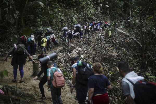 FILE - Migrants walk across the Darien Gap from Colombia to Panama in hopes of reaching the U.S., May 9, 2023. (AP Photo/Ivan Valencia, File)